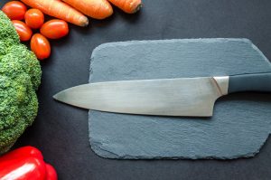 Close-up of fresh vegetables with a chef